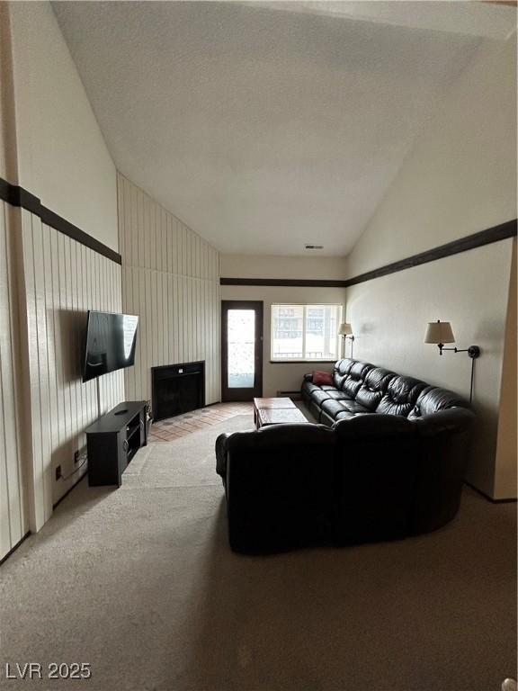 living area featuring carpet floors and lofted ceiling