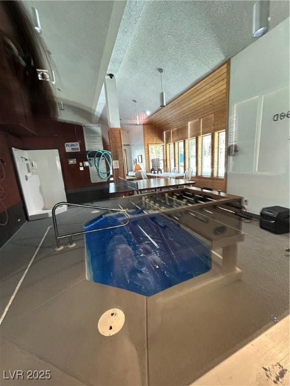 kitchen featuring lofted ceiling and a textured ceiling