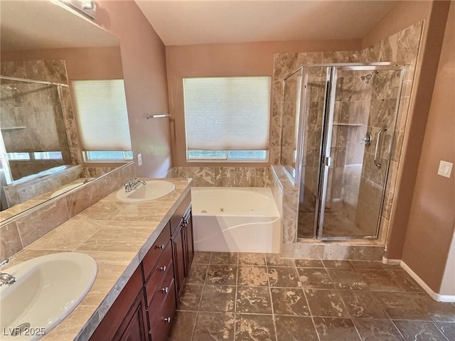 full bathroom with a stall shower, a sink, and a jetted tub