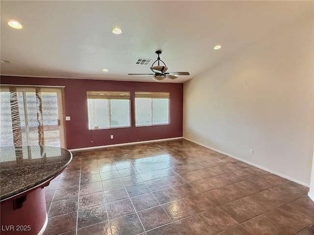 interior space with baseboards, visible vents, a ceiling fan, and recessed lighting