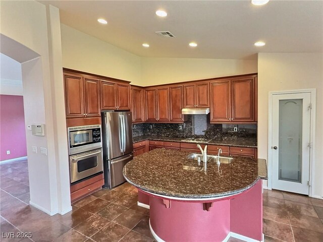 kitchen featuring tasteful backsplash, lofted ceiling, visible vents, appliances with stainless steel finishes, and a sink