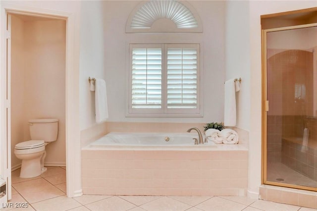 full bath with toilet, tile patterned flooring, a bath, and a shower stall