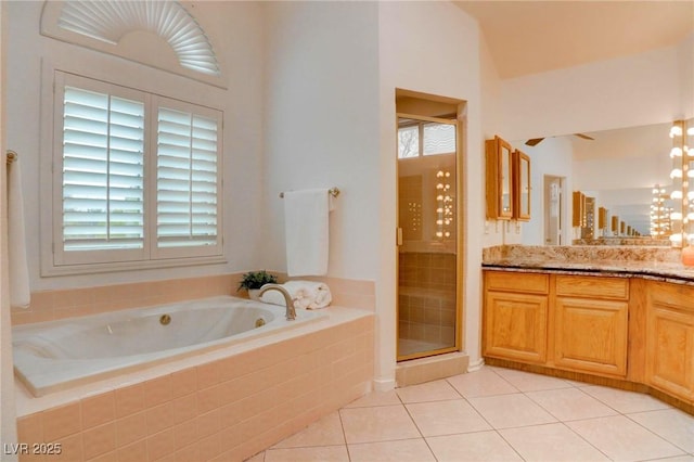 full bathroom with a garden tub, a shower stall, vanity, and tile patterned floors