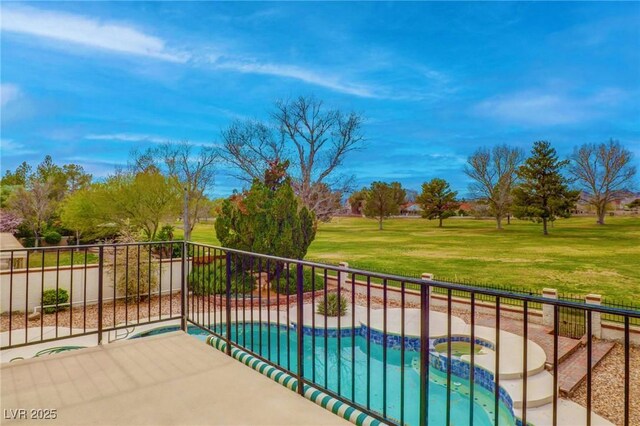 balcony with a patio area and a pool with connected hot tub