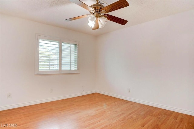 unfurnished room featuring a ceiling fan, baseboards, and light wood finished floors