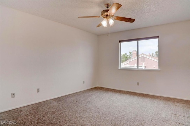 carpeted spare room featuring a ceiling fan, a textured ceiling, and baseboards