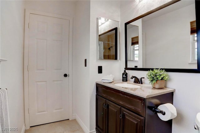 bathroom with tile patterned flooring, vanity, and baseboards