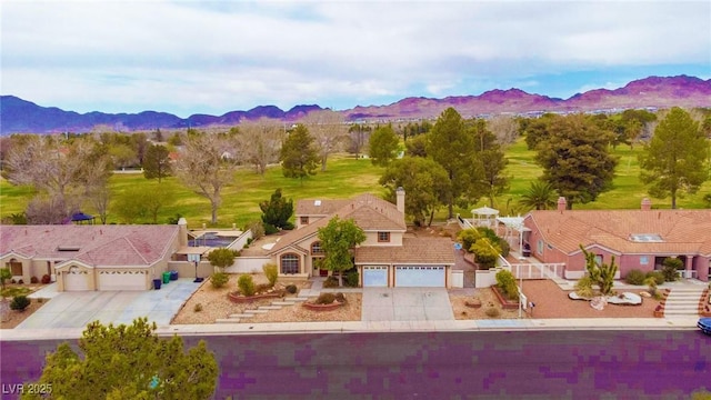 birds eye view of property with a residential view and a mountain view