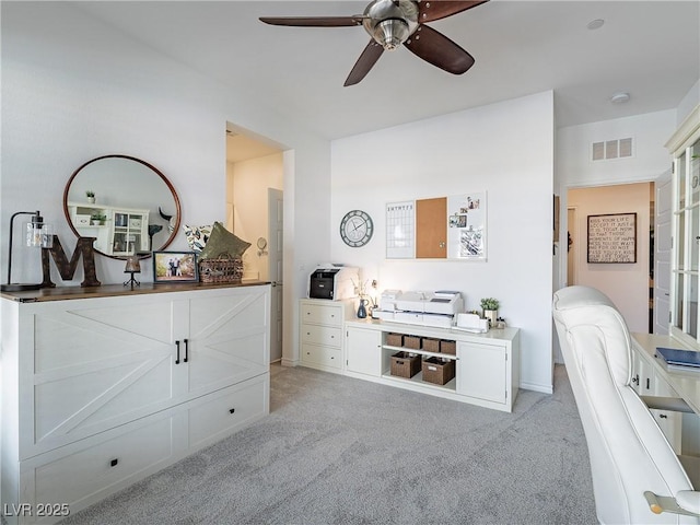 bedroom featuring a ceiling fan, light colored carpet, and visible vents