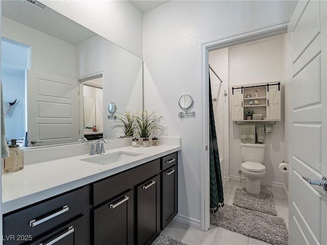 bathroom featuring a shower with shower curtain, vanity, toilet, and tile patterned floors