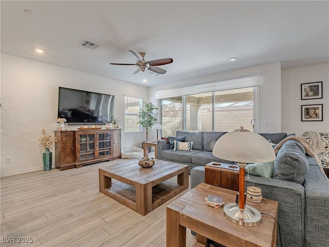 living room with light wood finished floors, recessed lighting, visible vents, and a ceiling fan