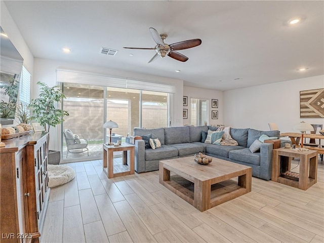 living area featuring ceiling fan, light wood finished floors, visible vents, and recessed lighting