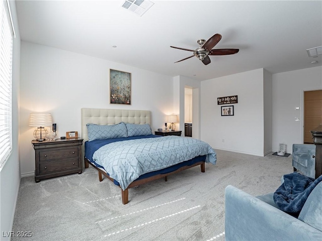 carpeted bedroom featuring ceiling fan, visible vents, and baseboards