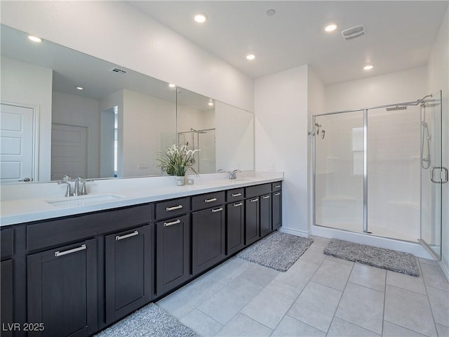 full bathroom with recessed lighting, a sink, a shower stall, and double vanity