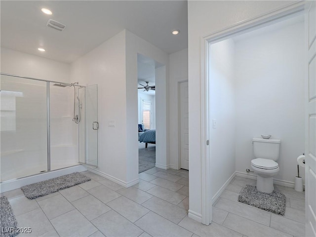 ensuite bathroom featuring toilet, a stall shower, visible vents, and recessed lighting