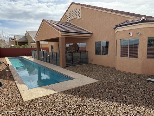 view of pool featuring a patio area, a fenced in pool, and a fenced backyard