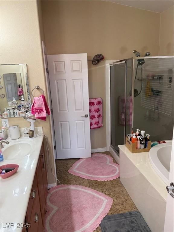 bathroom featuring tile patterned flooring, a shower stall, vanity, and a garden tub