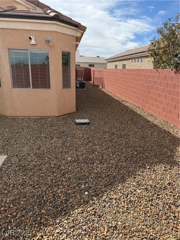 view of yard featuring central air condition unit and a fenced backyard