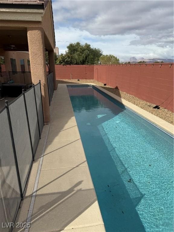 view of swimming pool with a fenced backyard and a fenced in pool