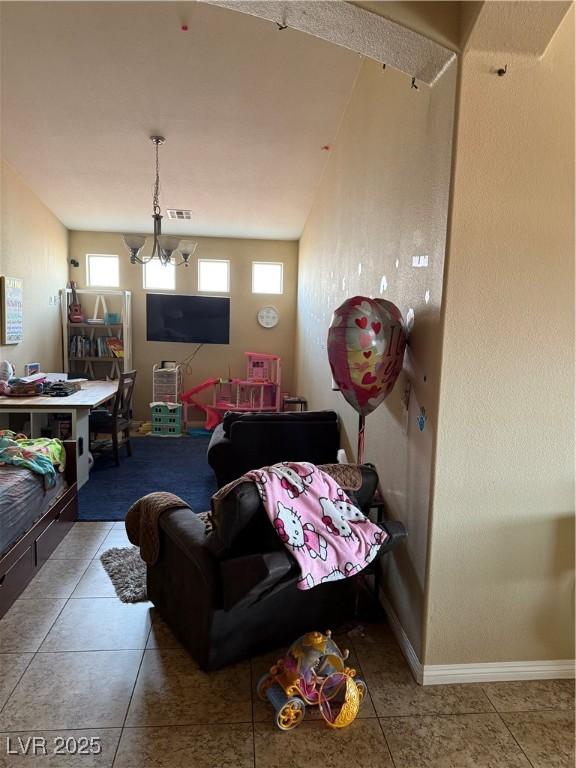 living room with tile patterned flooring, an inviting chandelier, baseboards, and visible vents