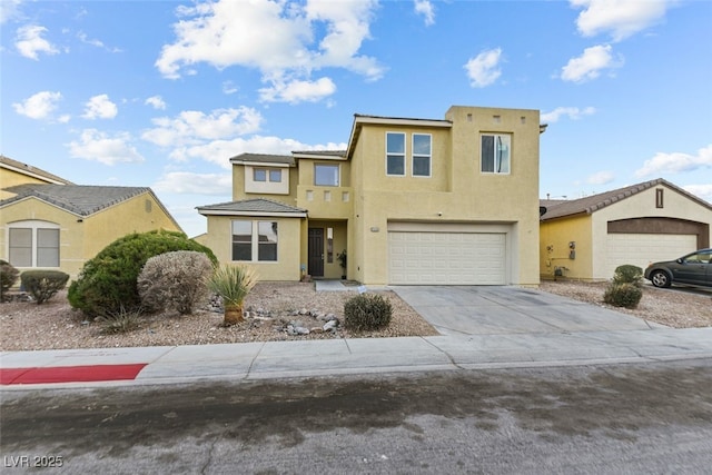 view of front facade featuring driveway, an attached garage, and stucco siding