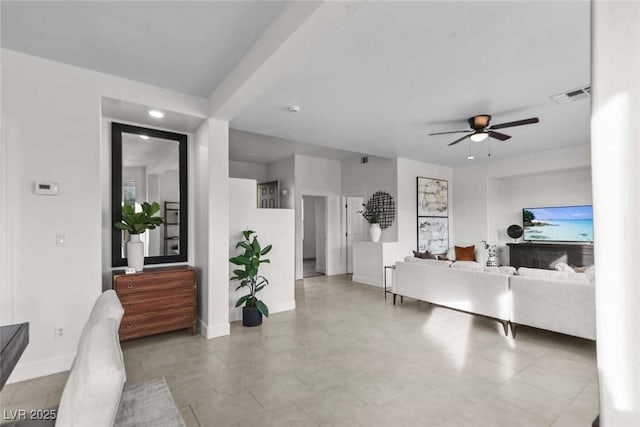 living room featuring visible vents, ceiling fan, and baseboards