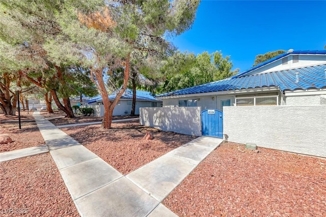 view of home's community featuring a fenced front yard and a gate