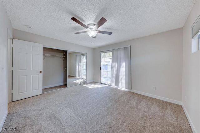 unfurnished bedroom with a closet, carpet, a ceiling fan, and baseboards