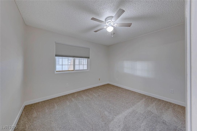 carpeted spare room with a textured ceiling, a ceiling fan, and baseboards