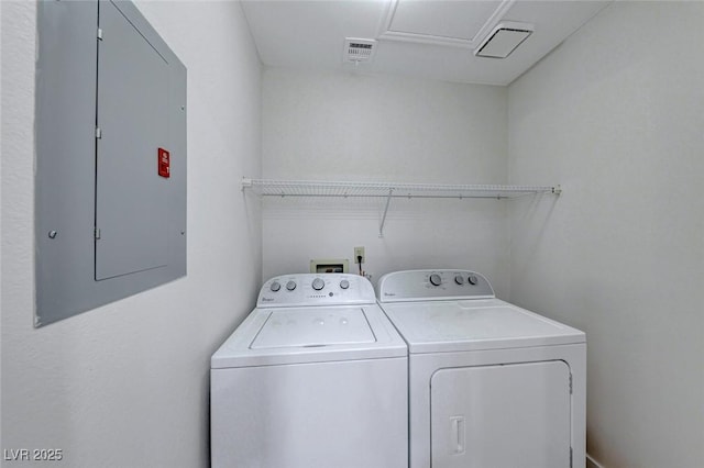 laundry area featuring visible vents, laundry area, electric panel, and washer and dryer