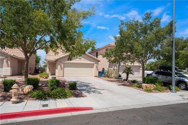 view of front of property featuring a garage, driveway, a tiled roof, and stucco siding