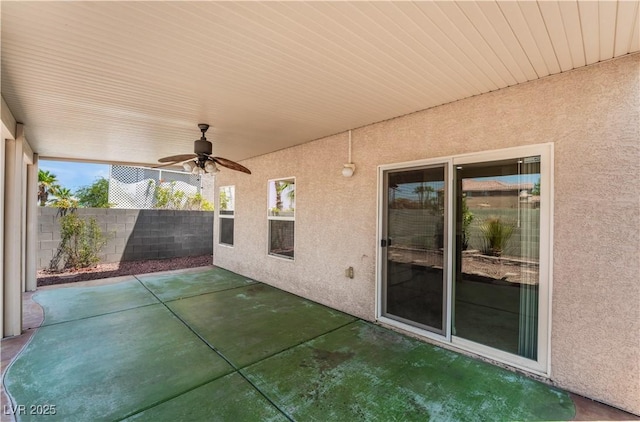 view of patio / terrace with fence and a ceiling fan