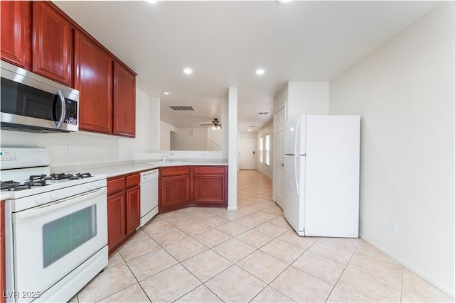 kitchen with light tile patterned floors, light countertops, visible vents, a ceiling fan, and white appliances