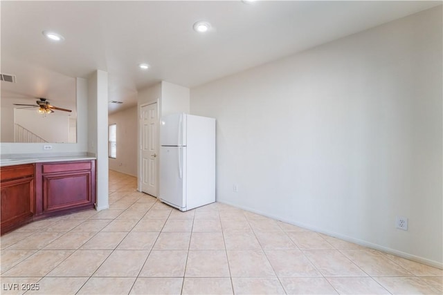 kitchen with a ceiling fan, freestanding refrigerator, light tile patterned flooring, light countertops, and recessed lighting