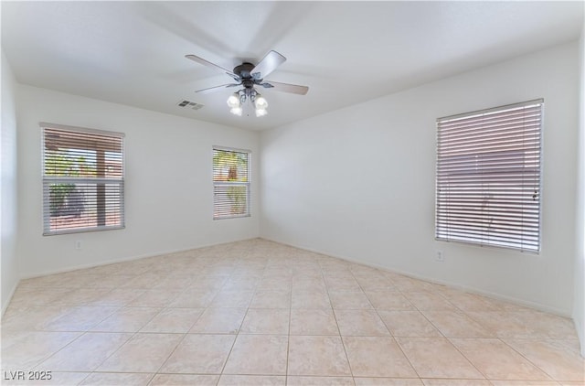 unfurnished room featuring light tile patterned floors, visible vents, and a ceiling fan