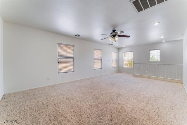 empty room with recessed lighting, visible vents, ceiling fan, and carpet flooring