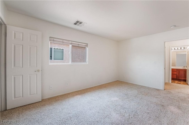 unfurnished bedroom with carpet and visible vents