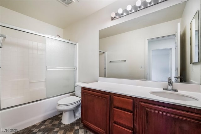 bathroom with visible vents, vanity, toilet, and combined bath / shower with glass door