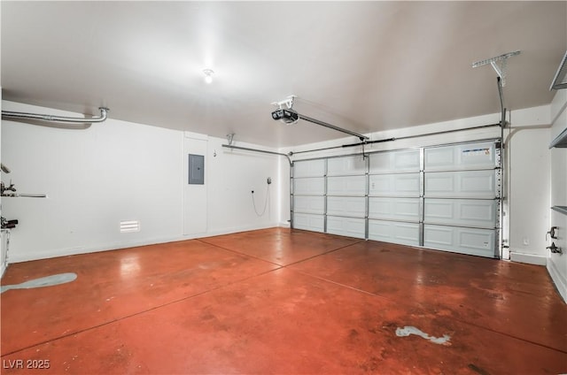 garage featuring a garage door opener, electric panel, and baseboards