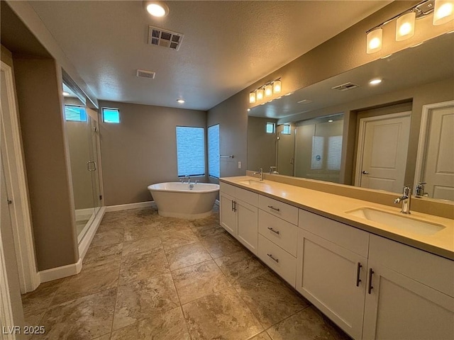 full bathroom with visible vents, a sink, a soaking tub, and a shower stall
