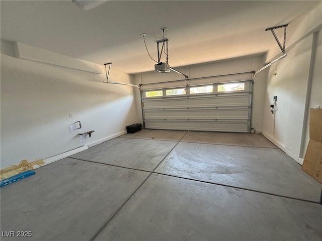 garage with a garage door opener and baseboards