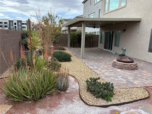 view of patio / terrace with a fenced backyard and a fire pit