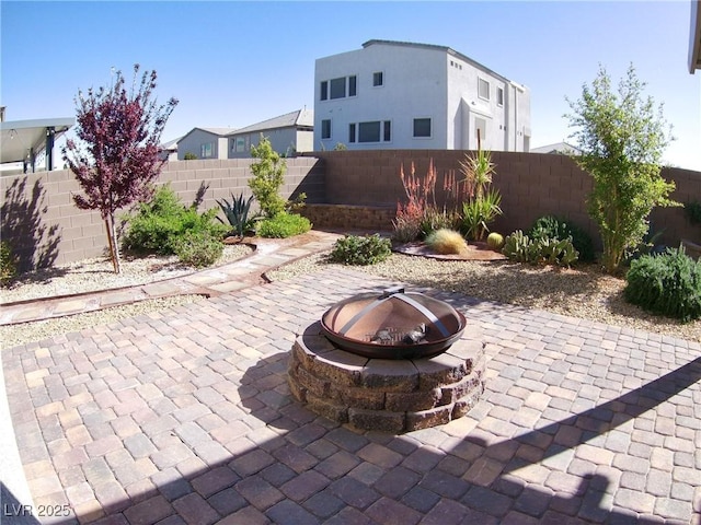 view of patio / terrace with an outdoor fire pit and a fenced backyard