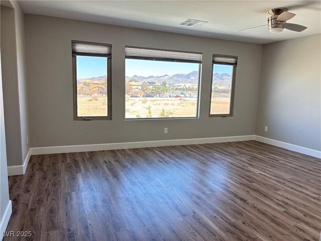 unfurnished room with plenty of natural light, baseboards, and visible vents