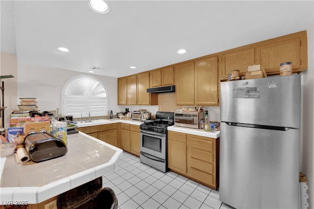 kitchen featuring light tile patterned floors, tile counters, recessed lighting, appliances with stainless steel finishes, and under cabinet range hood