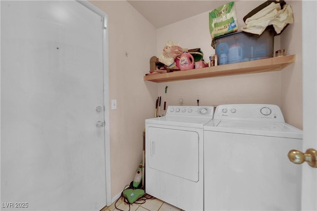 laundry area with laundry area, washer and dryer, and light tile patterned flooring