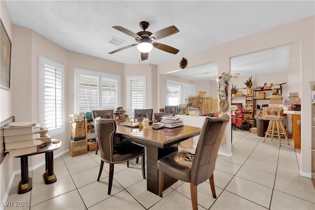 dining room with a ceiling fan, visible vents, baseboards, and light tile patterned floors