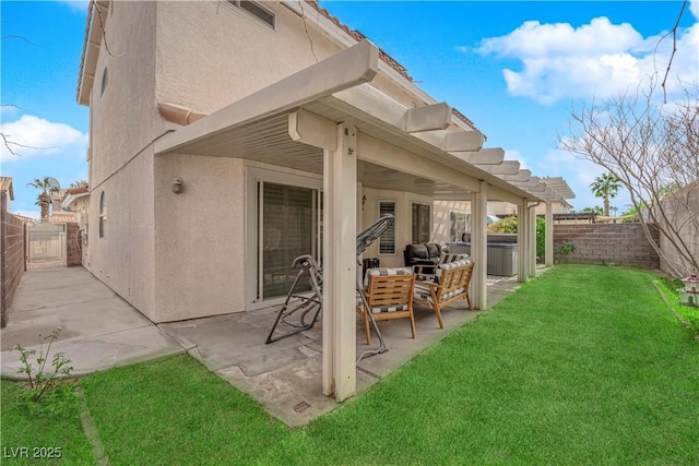 rear view of property featuring stucco siding, a patio, a fenced backyard, and a lawn