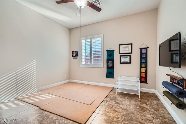 interior space featuring a ceiling fan, visible vents, and baseboards