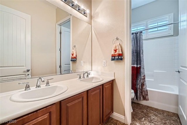 full bath featuring double vanity, shower / bath combo with shower curtain, a sink, and toilet